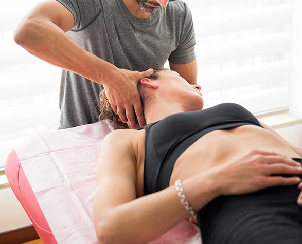 male chiropractor ajdusting female neck